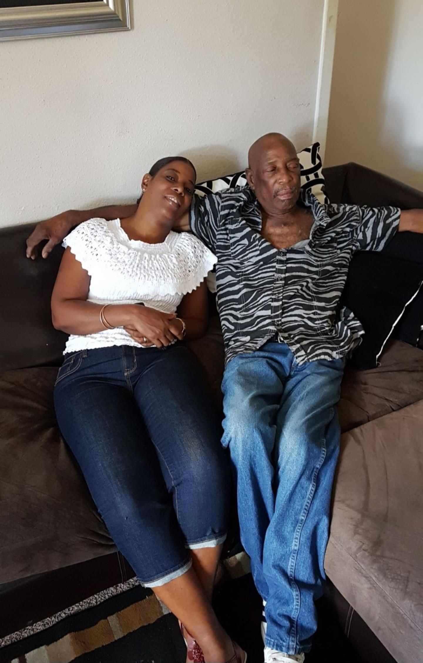 A man and woman lying on a couch