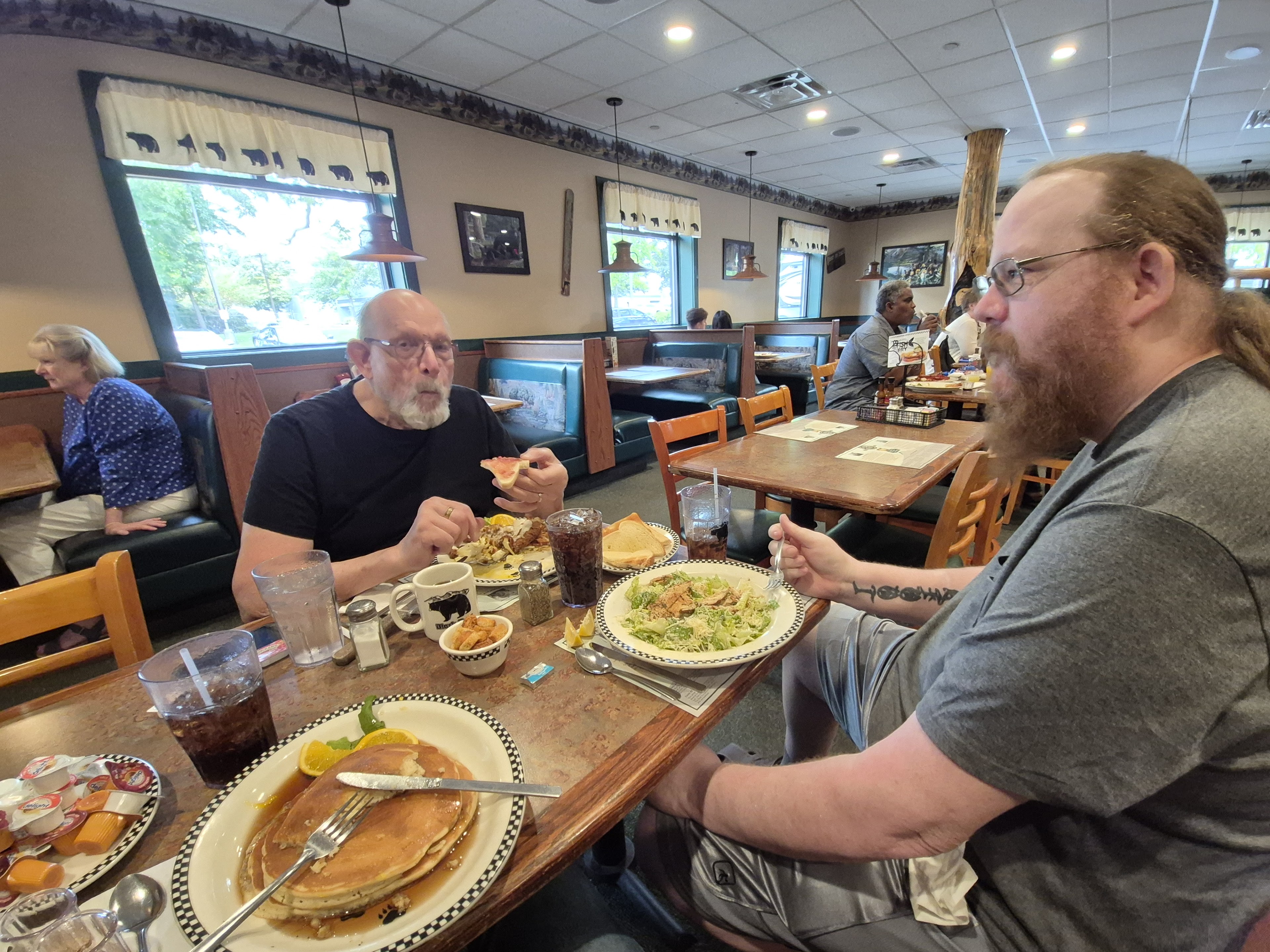 A group of men sitting at a table eating