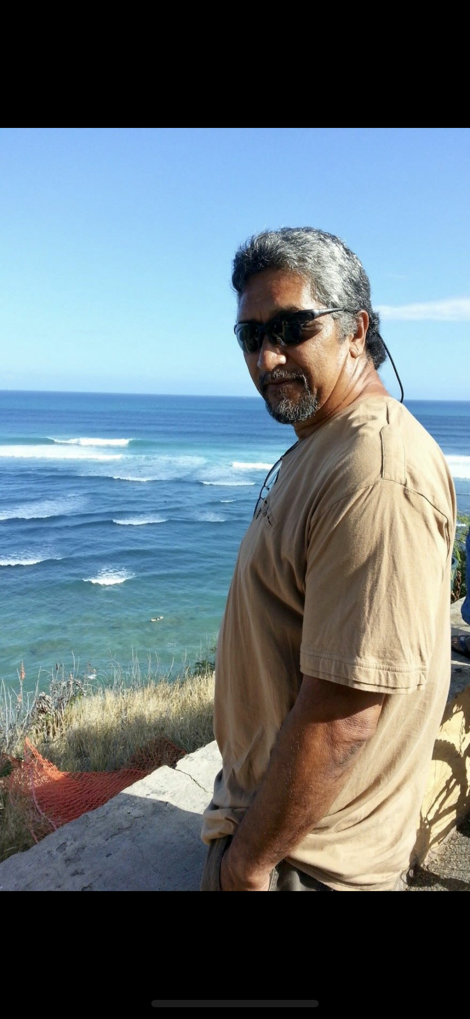 A man standing in front of a body of water