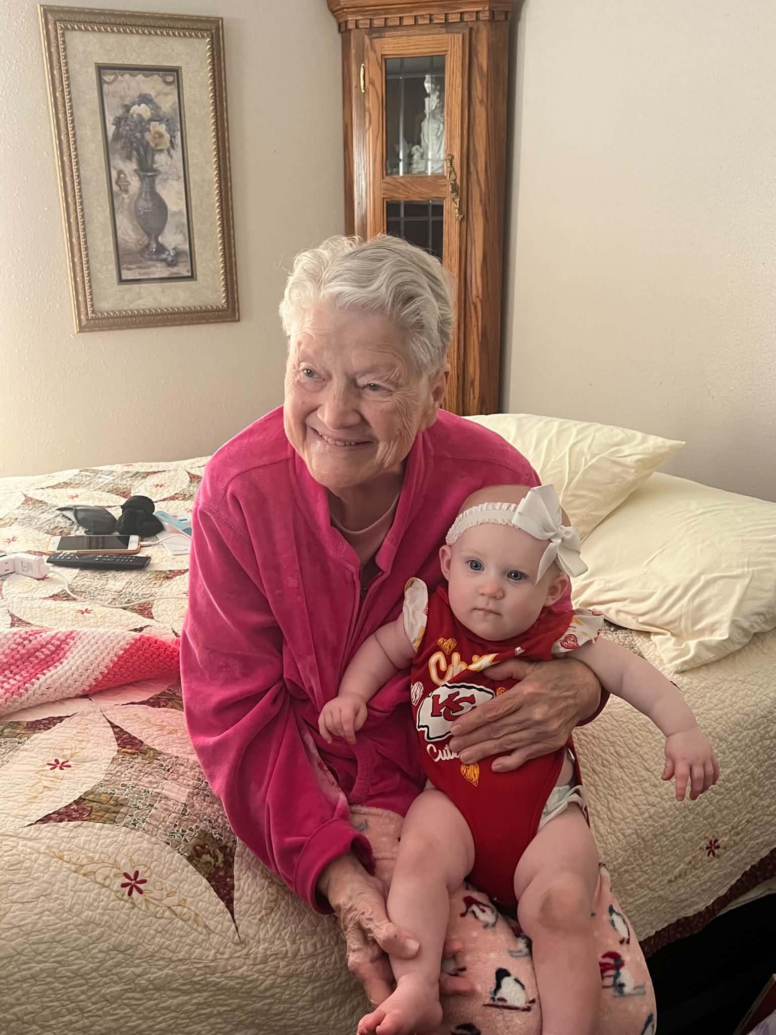 An old woman holding a baby