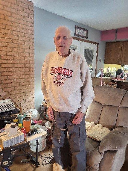 An old man standing in a living room