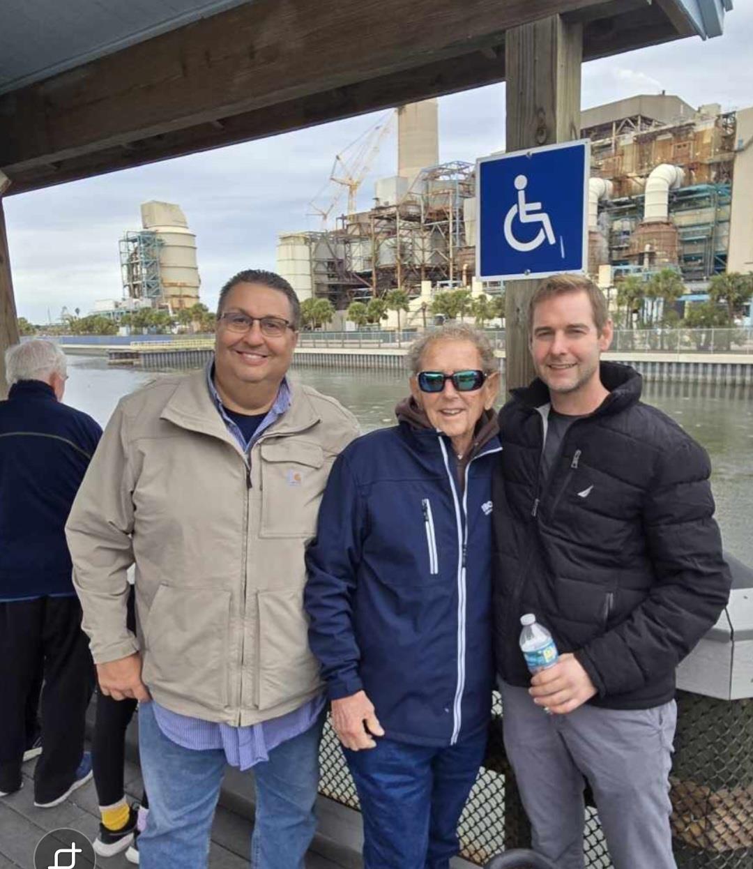 A group of people standing under a sign