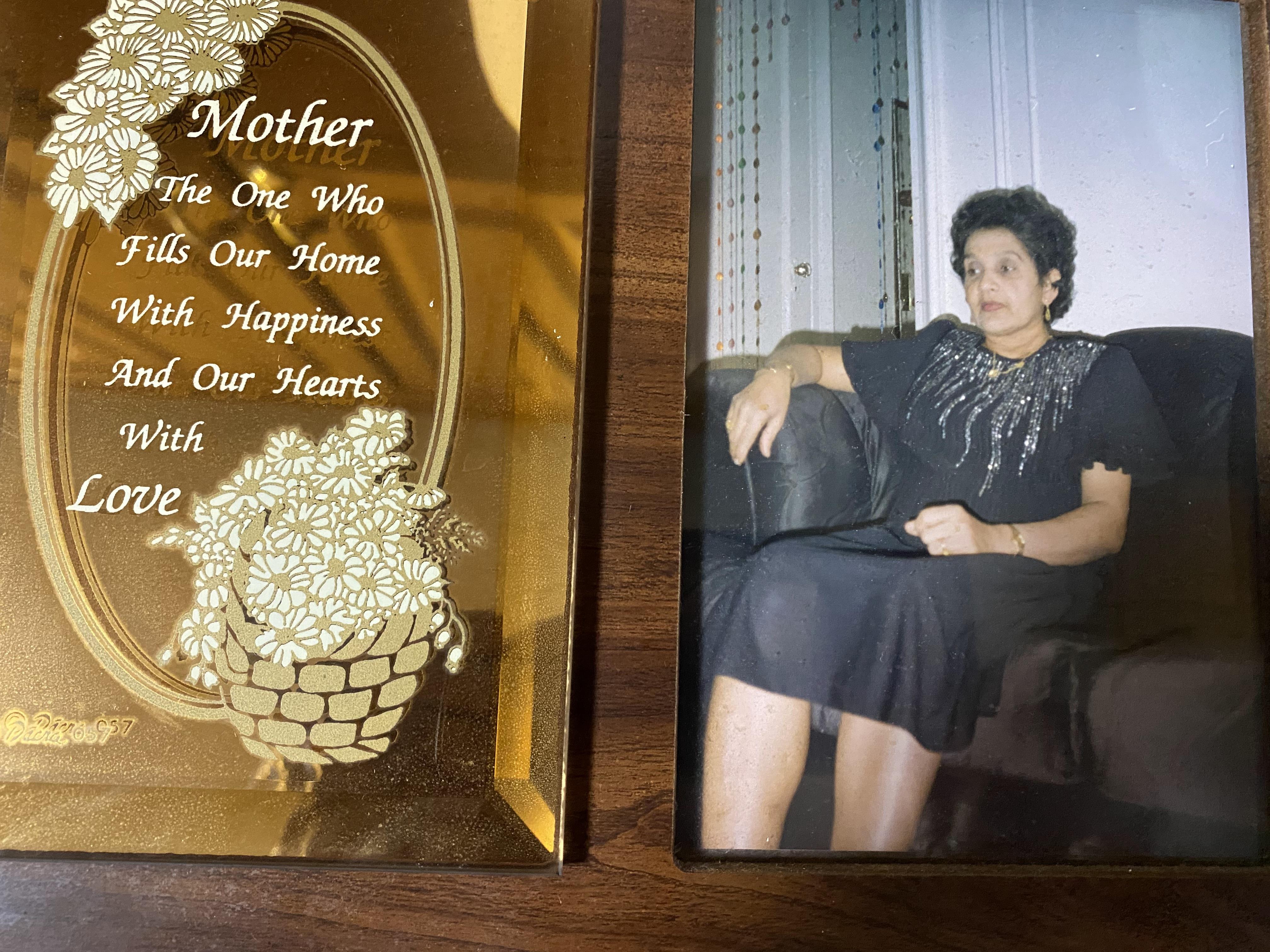 A framed picture of a woman sitting on a chair next to a picture of a woman