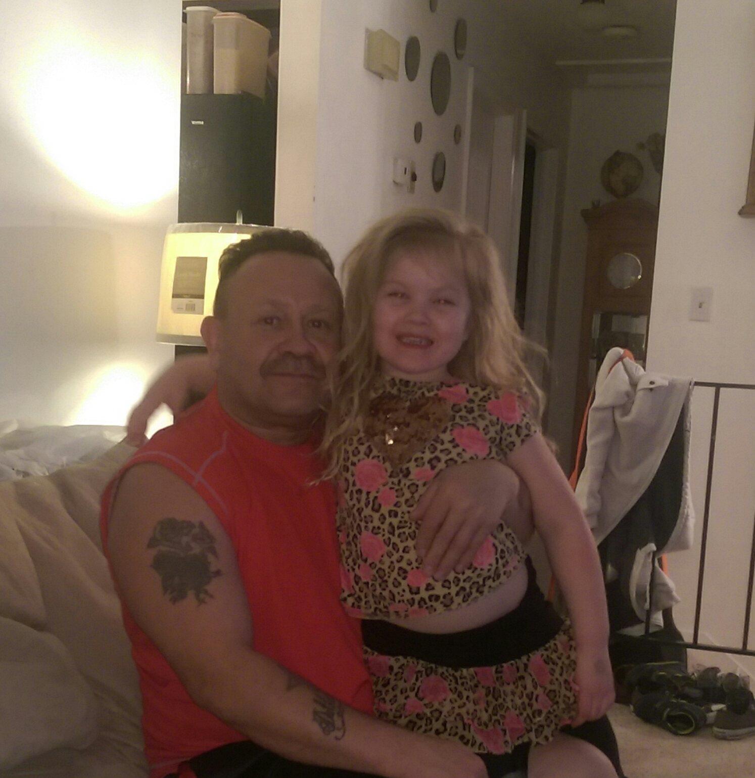 A man and a girl posing for a picture