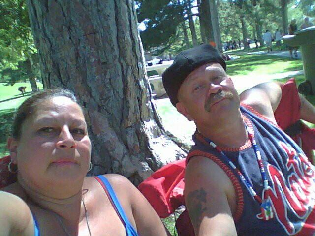 A man and woman sitting under a tree