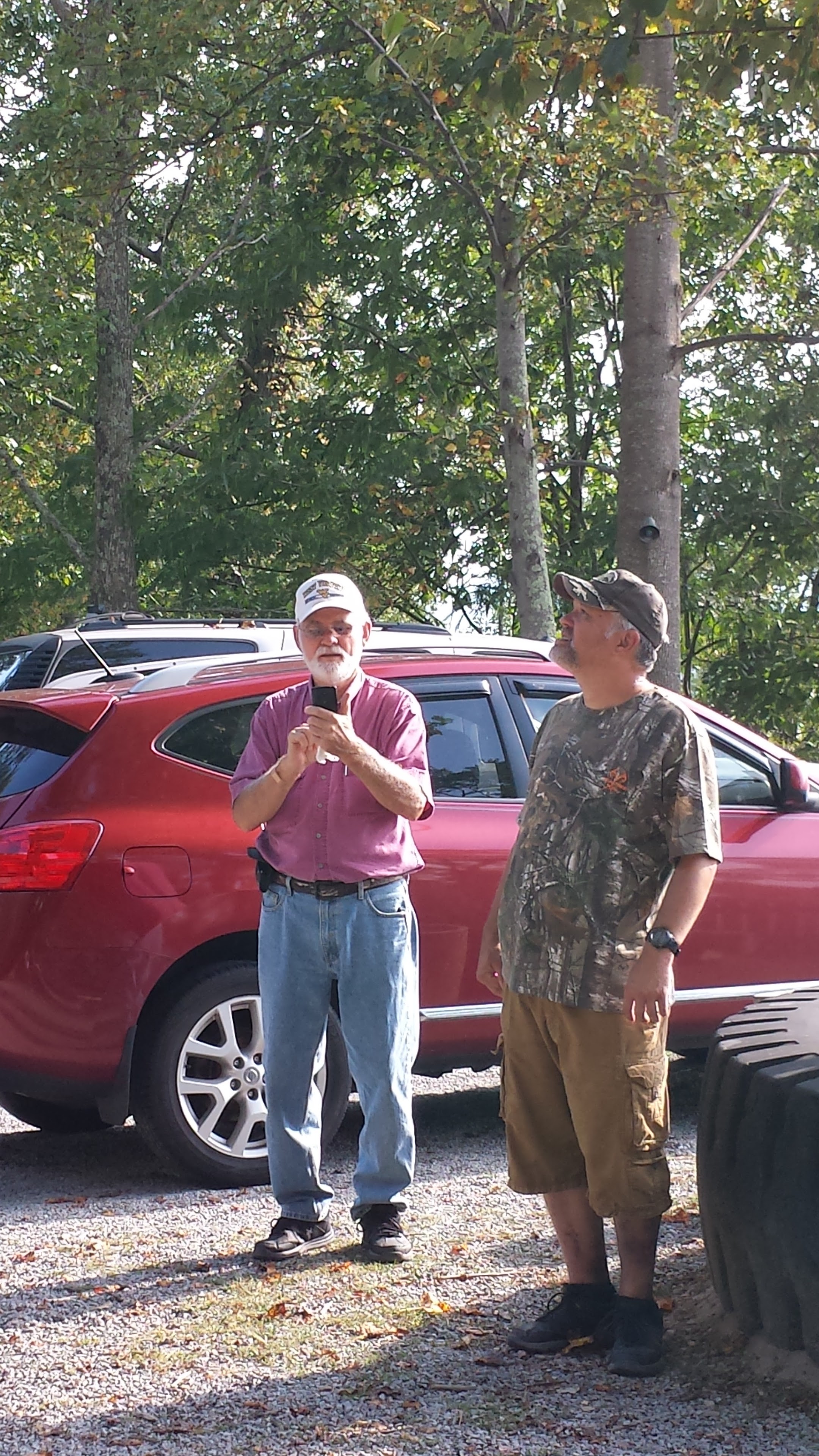 Two men standing in a parking lot