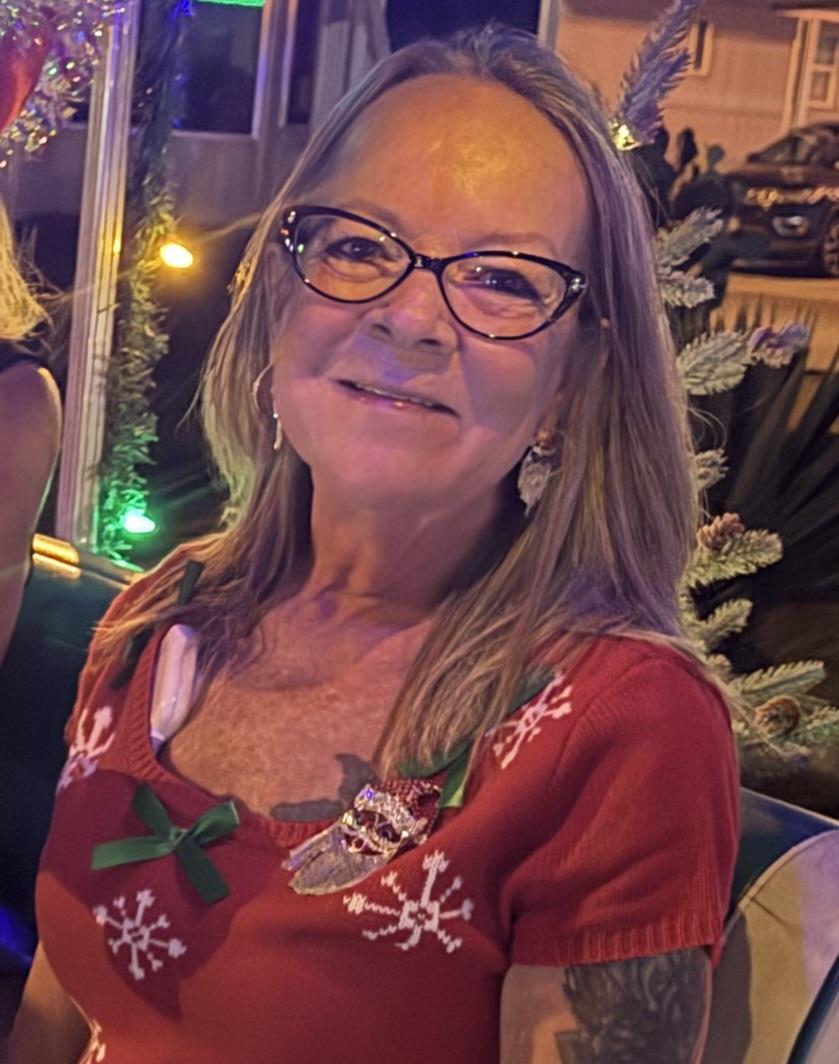 A woman wearing glasses and a red sweater