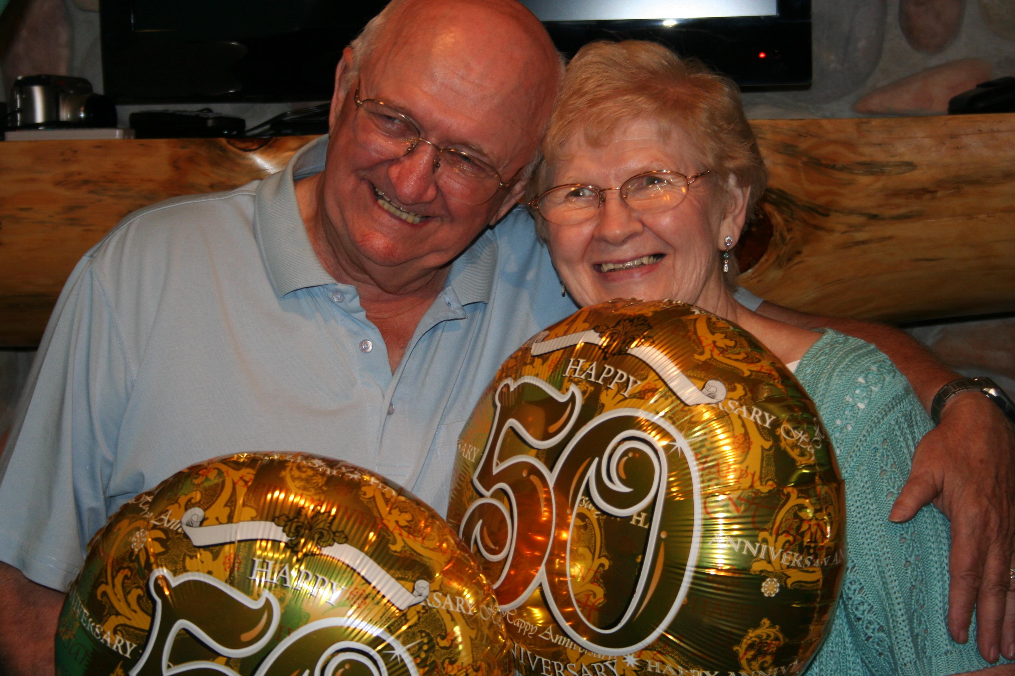 A man and woman holding balloons