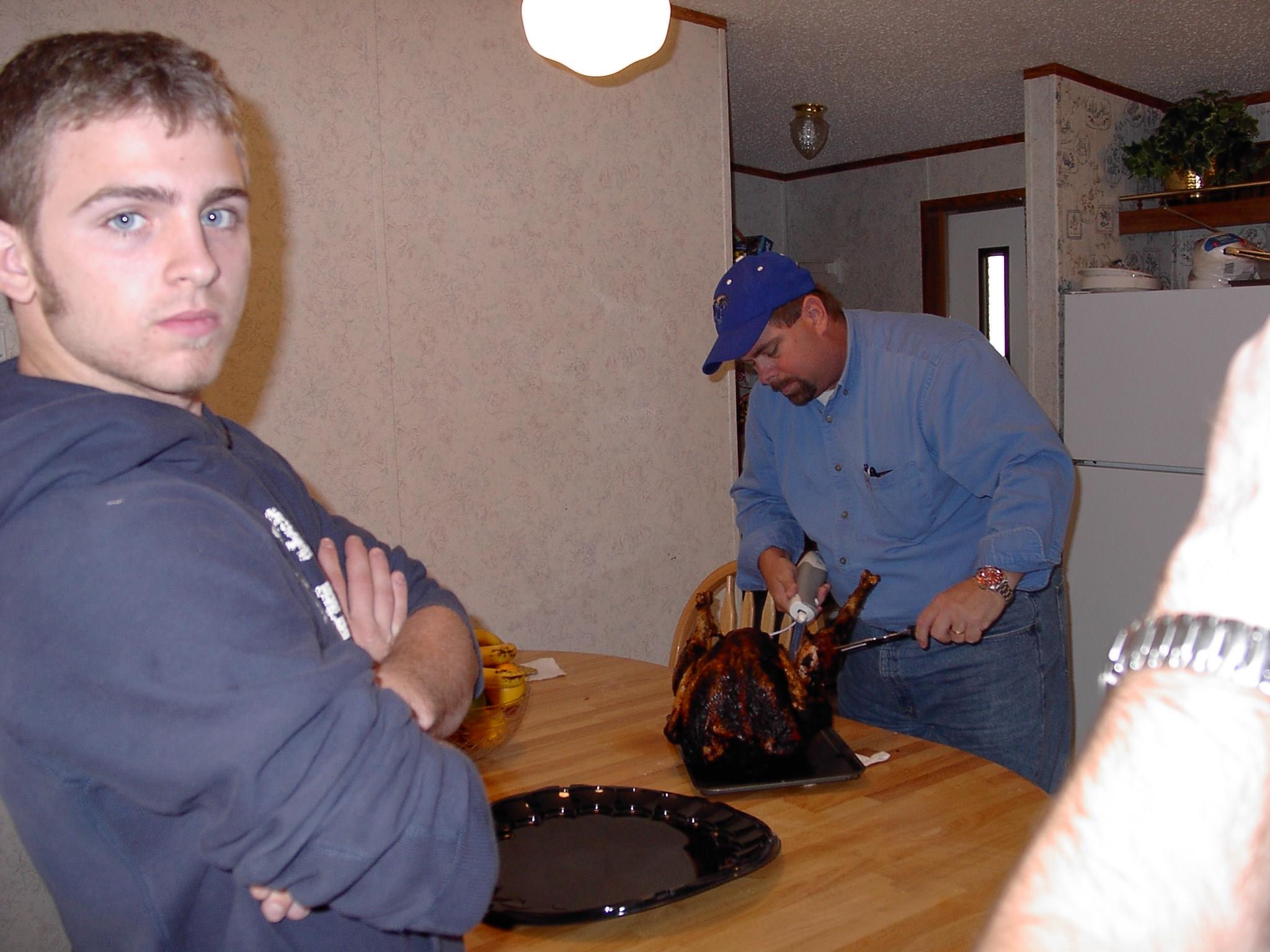 A man cutting a turkey