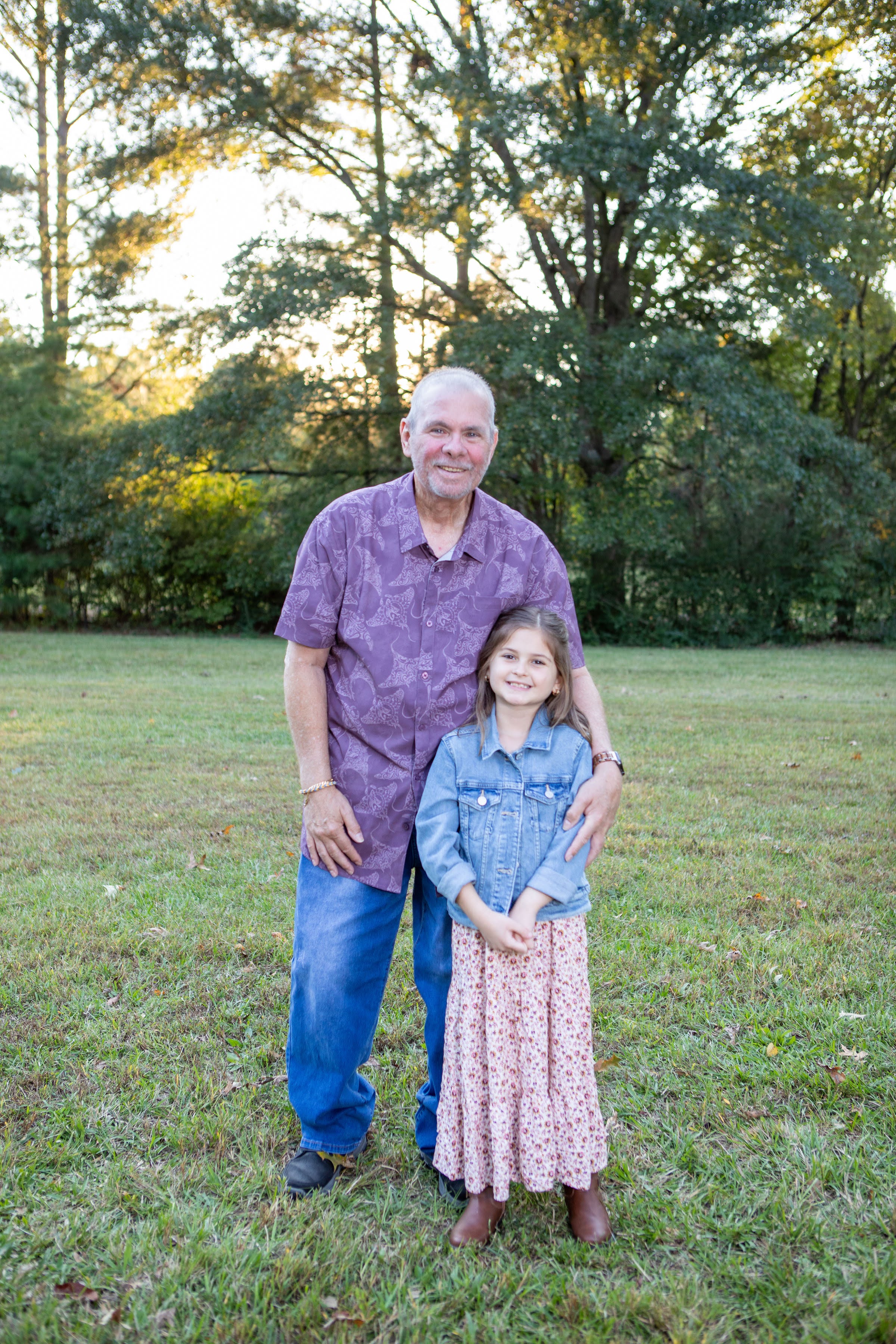 A man and girl standing in grass