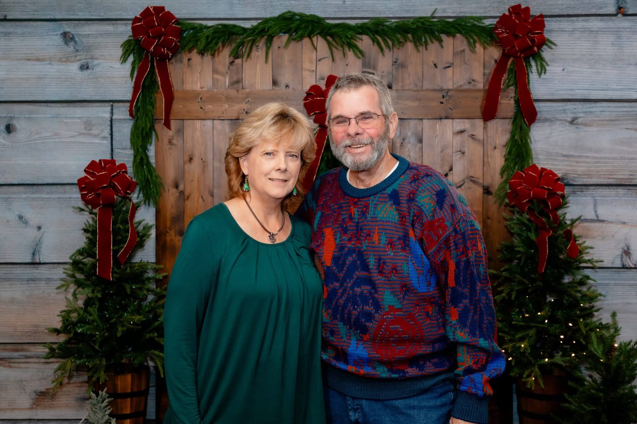 A man and woman standing in front of a door