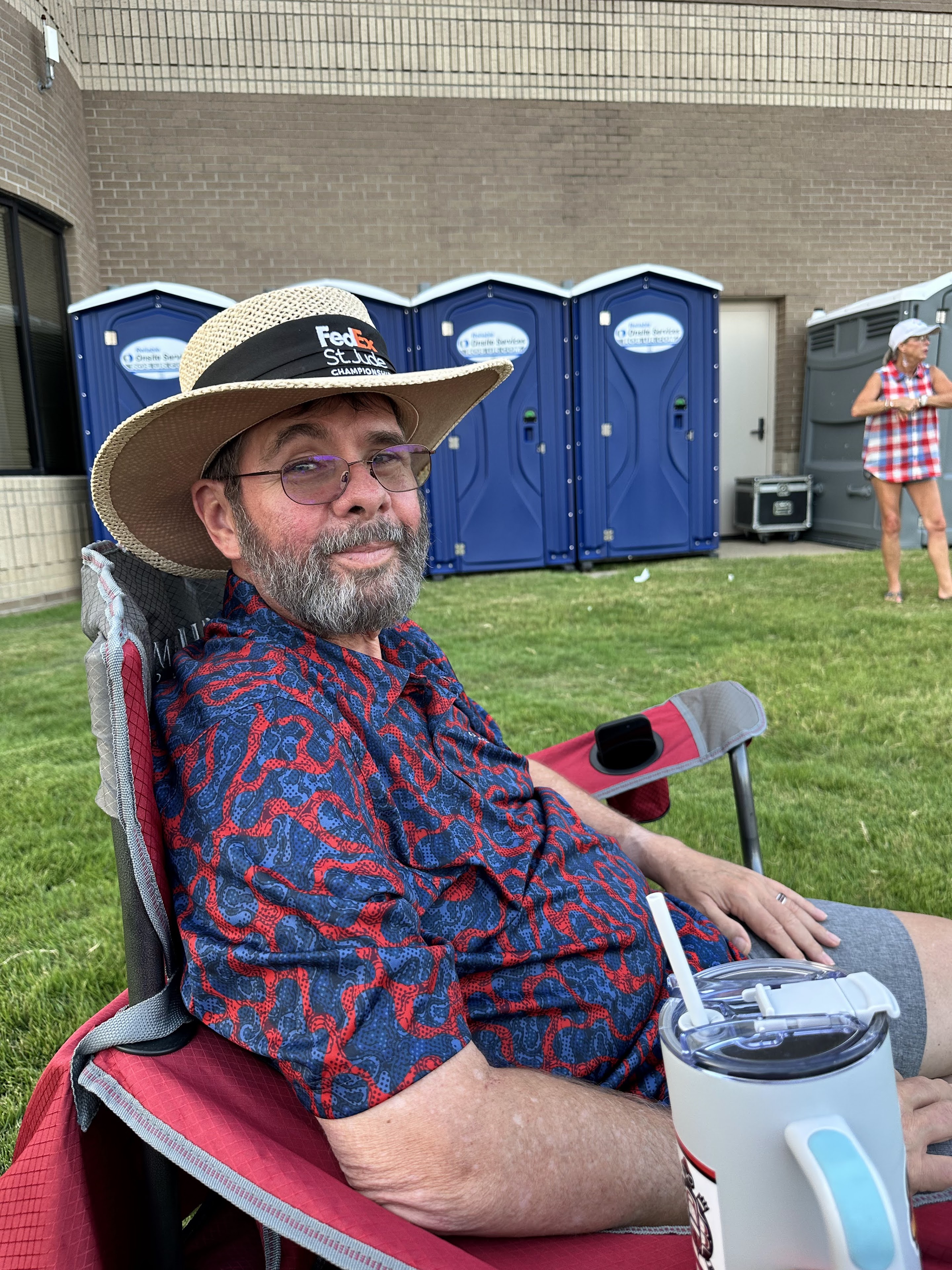 A man sitting in a chair in front of a building