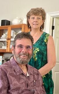 A man and woman standing in a kitchen