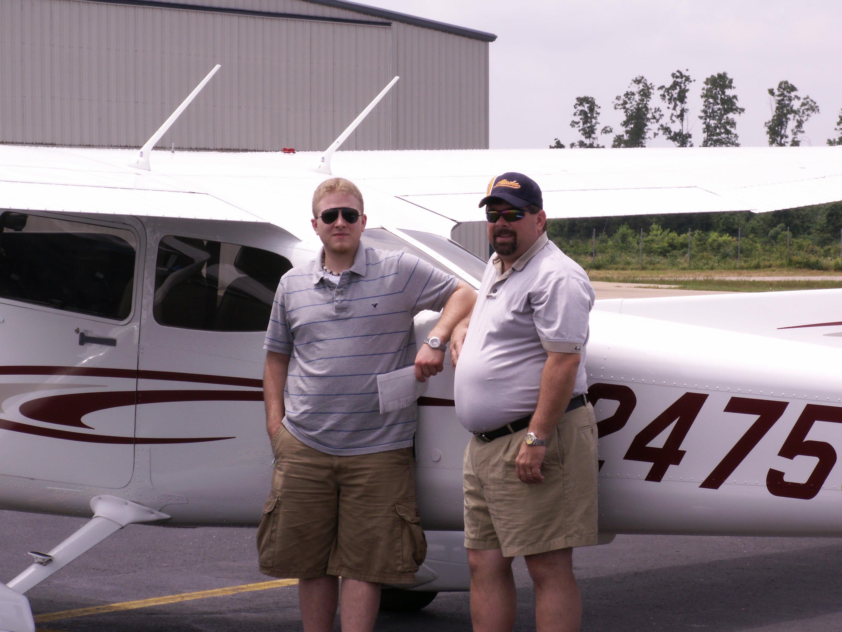 Men standing next to a plane