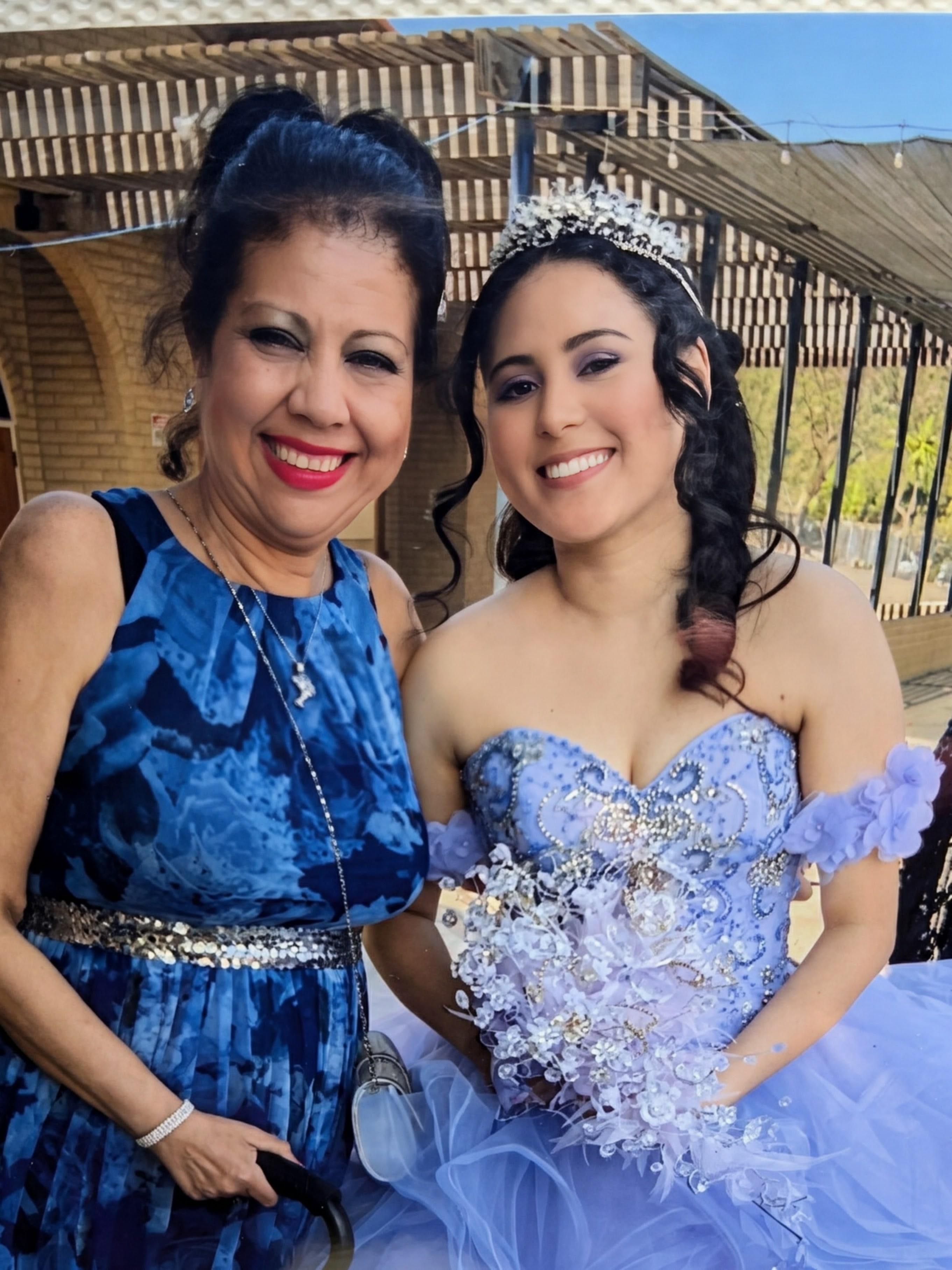 Two women in dresses posing for a picture