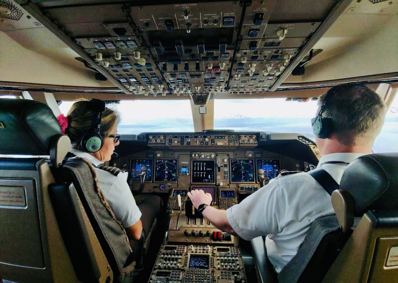 A couple of pilots in an airplane cockpit