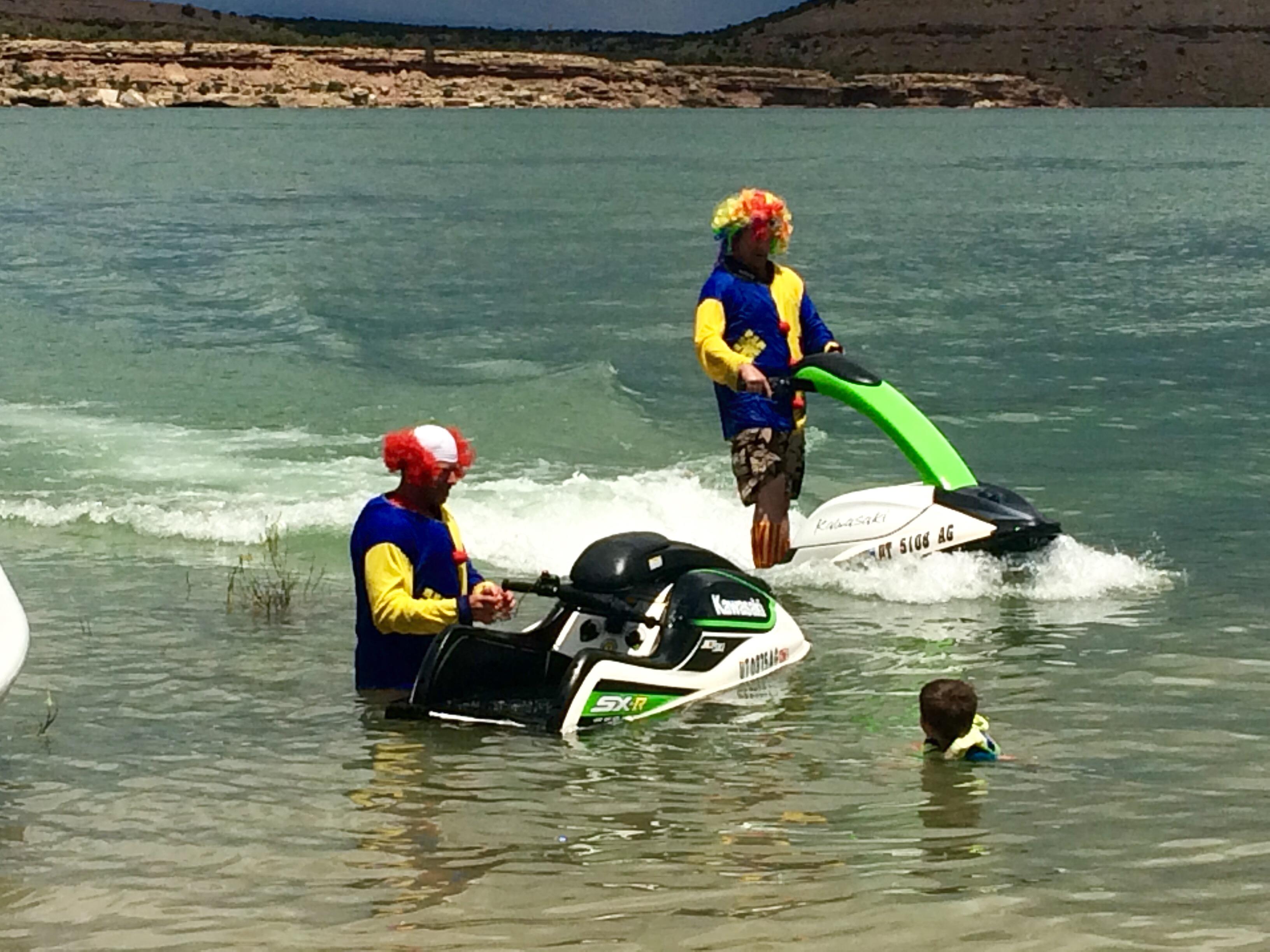 A group of people in a body of water with a jet ski