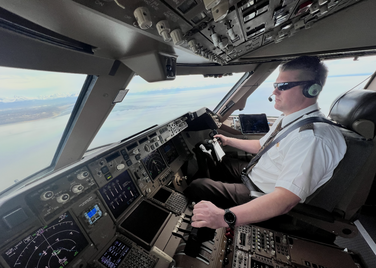 A man in a pilot's cockpit