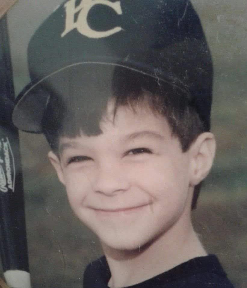 A boy wearing a baseball cap