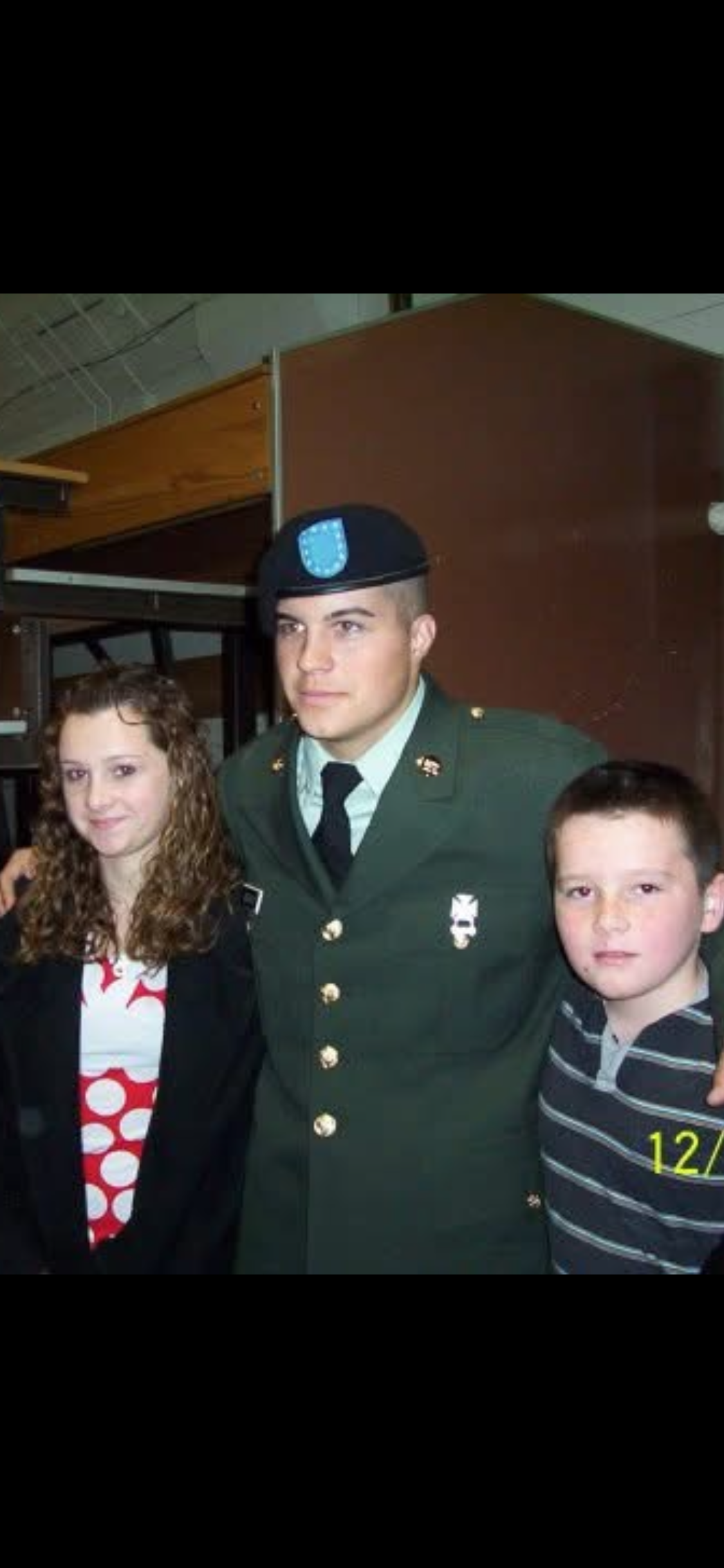 A man in a uniform with two children