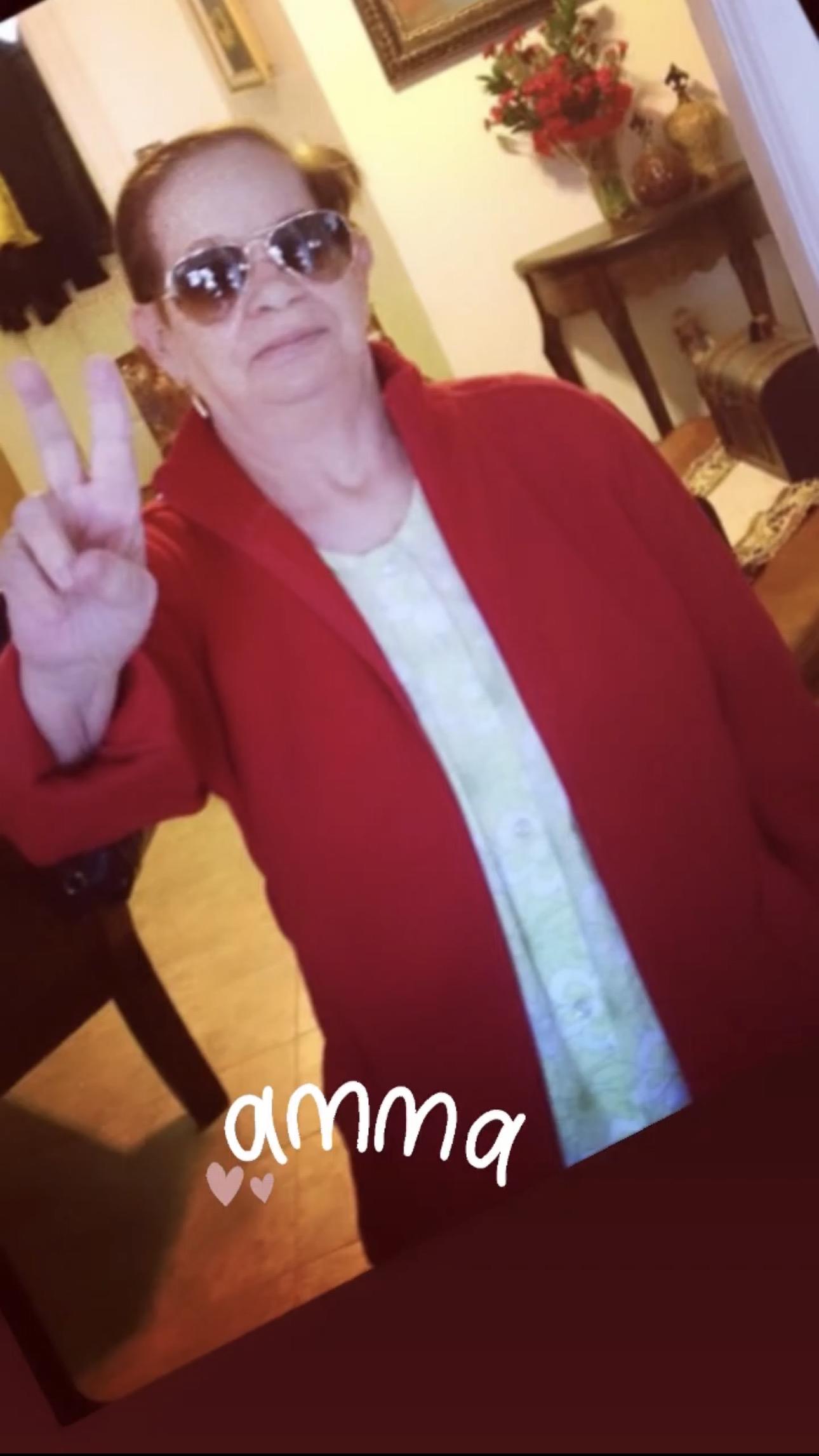 A woman wearing sunglasses and a red jacket