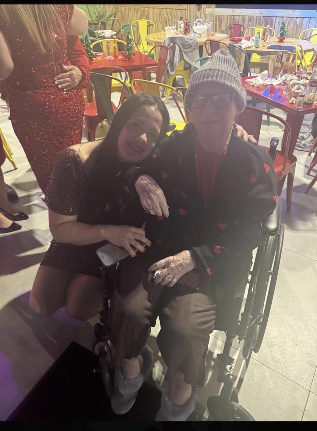 A man in a wheelchair with a woman in a hat