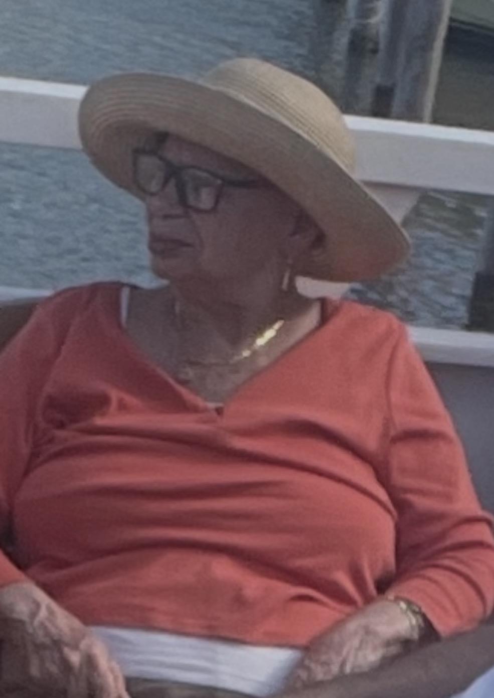 A woman wearing a hat and red shirt