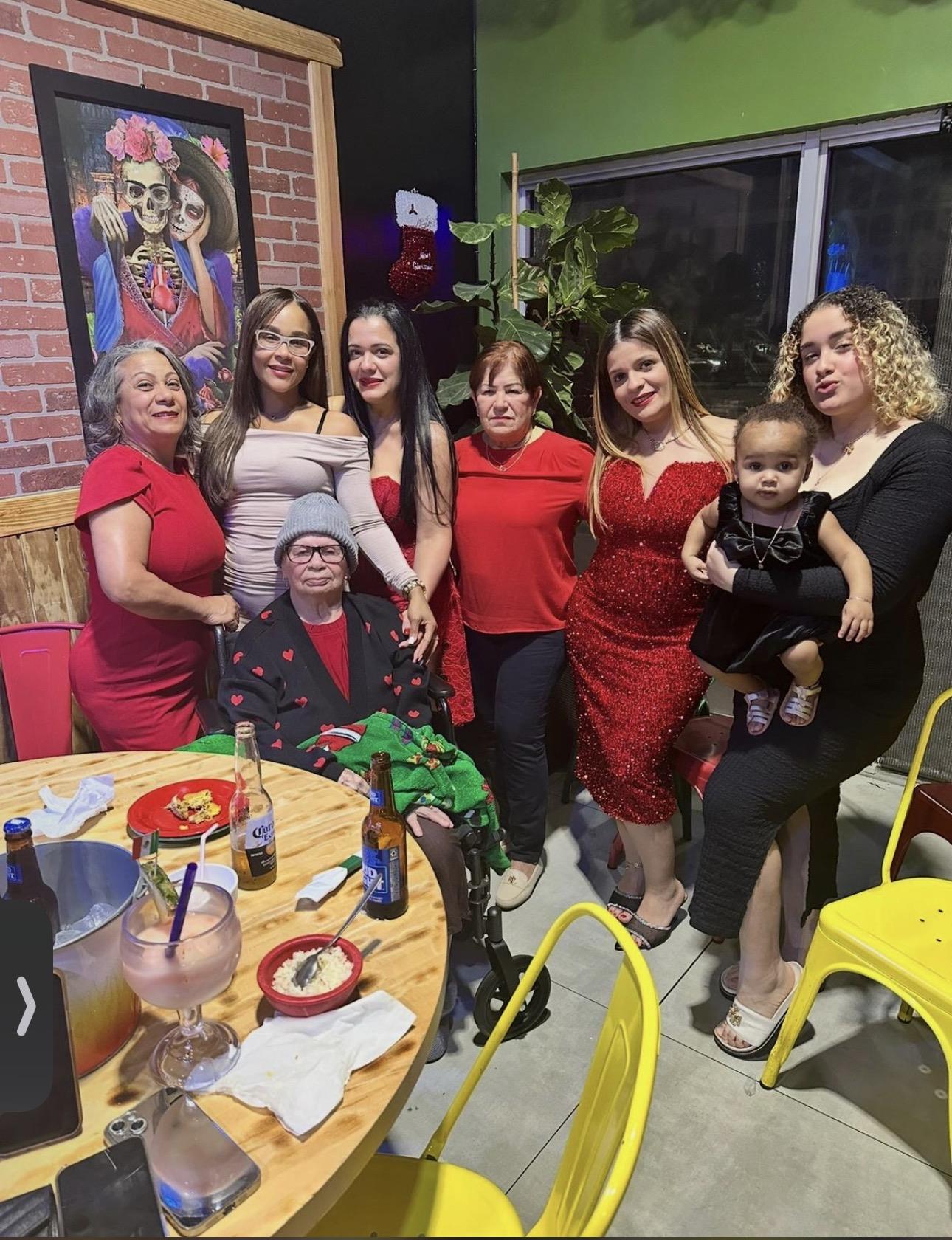 A group of women and a man posing for a photo