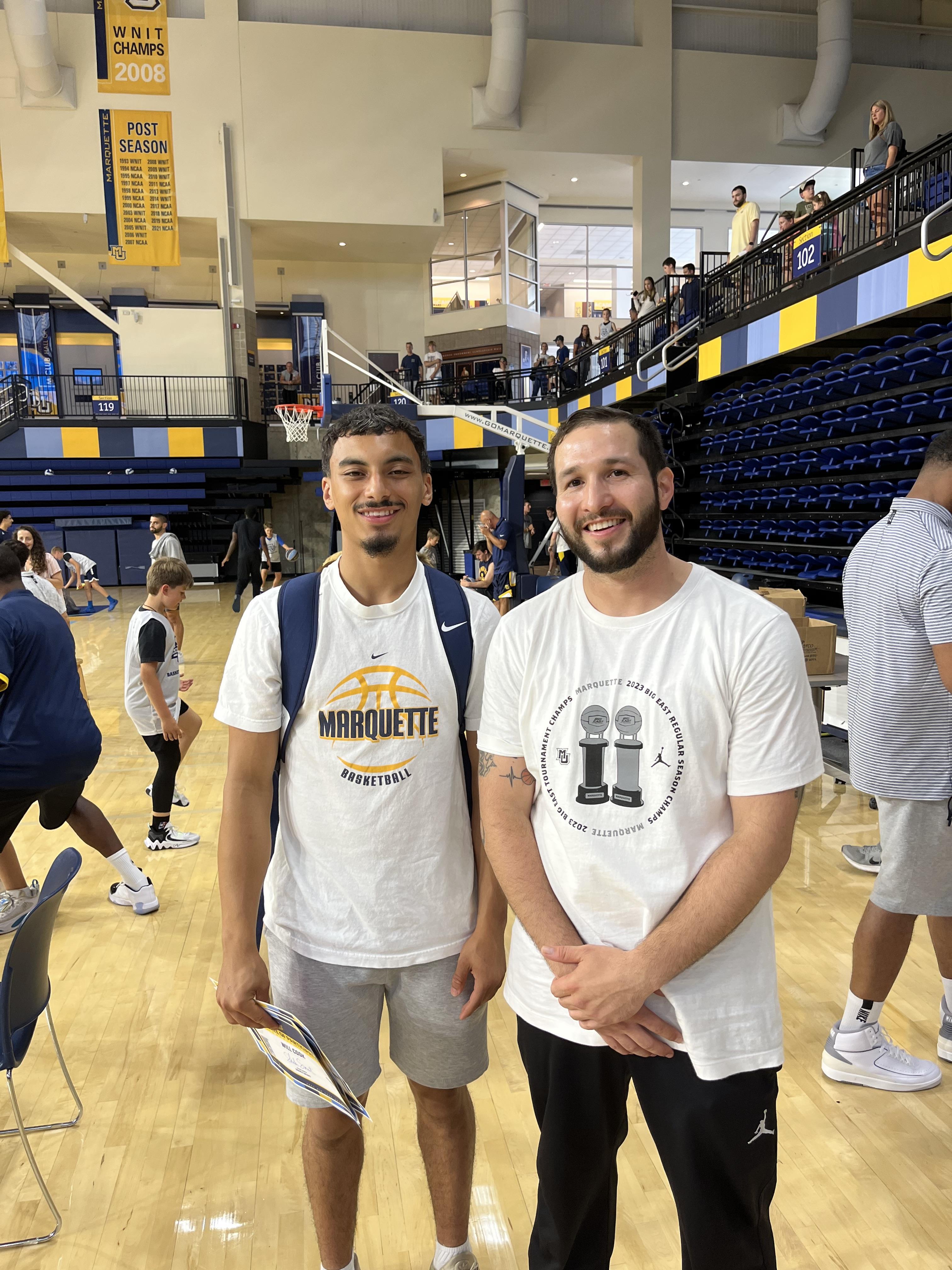 Two men standing in a gym