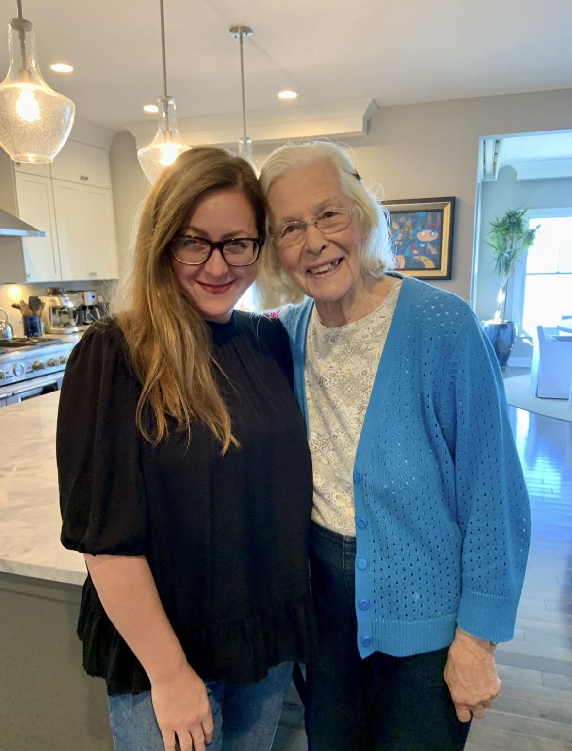 Two women standing together in a kitchen