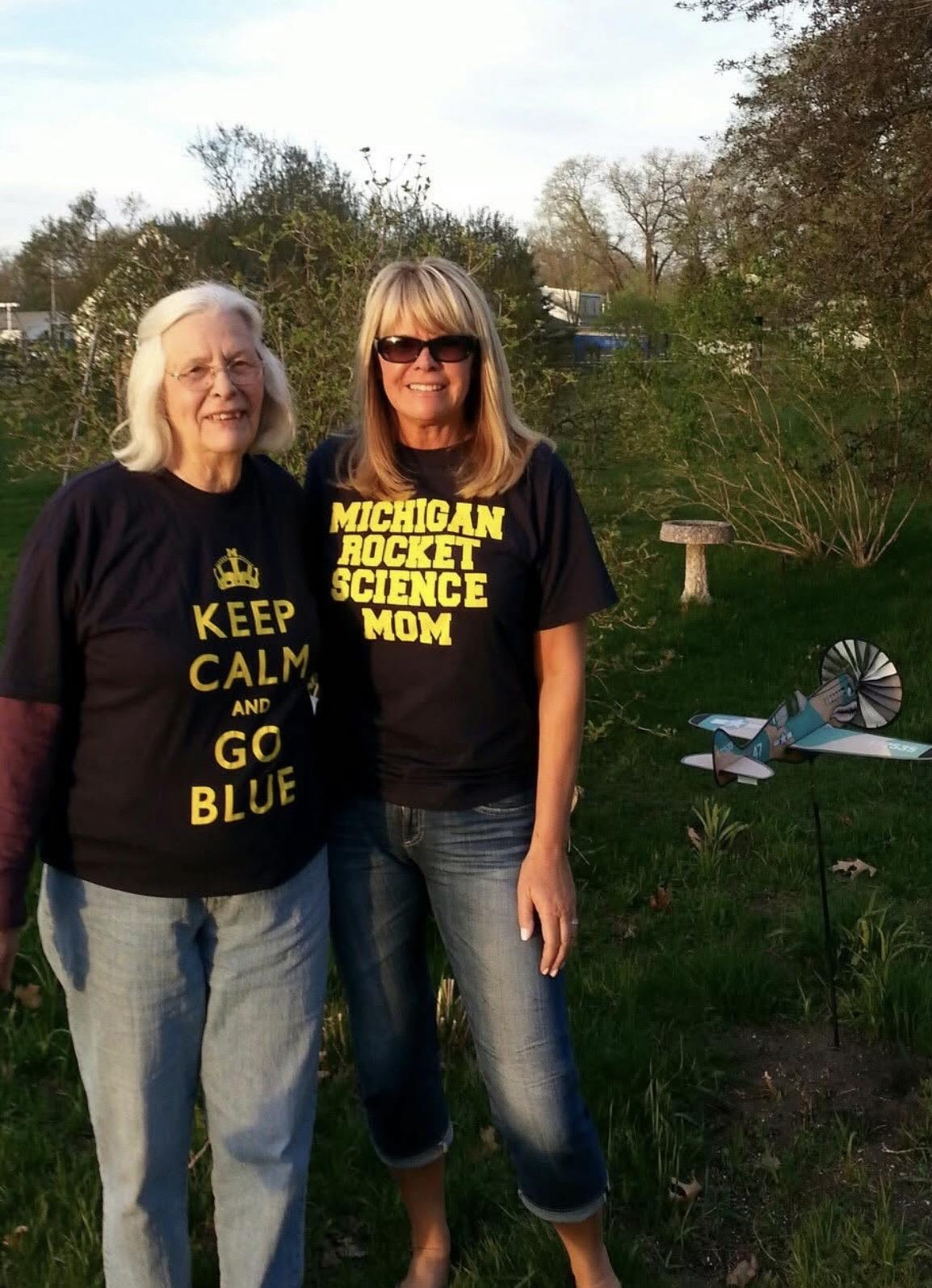 Two women standing in a yard