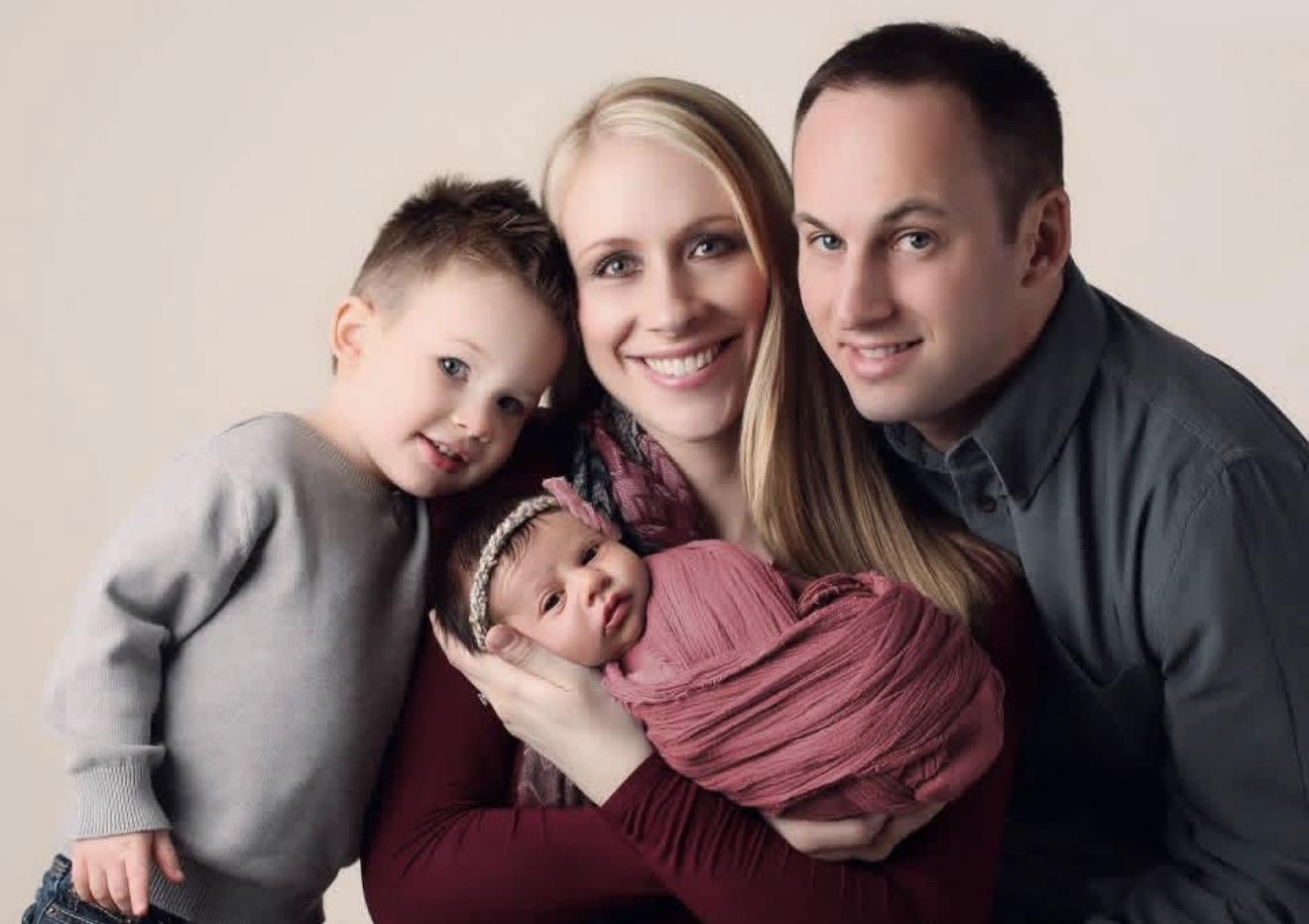 A man and woman holding a baby
