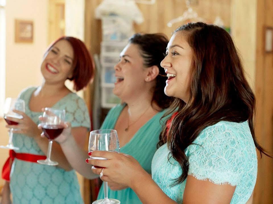 A group of women holding wine glasses
