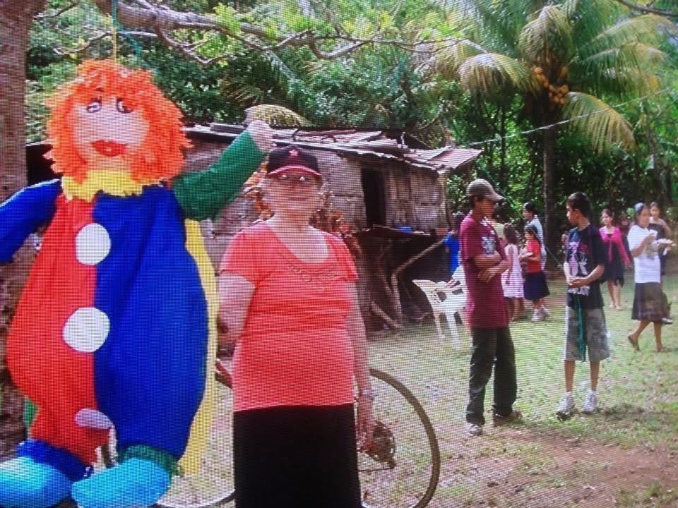 A group of people standing next to a person in a garment