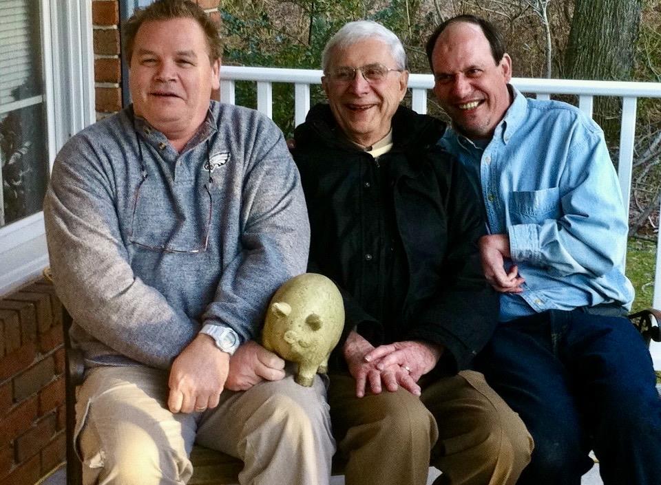 A group of men sitting on a porch