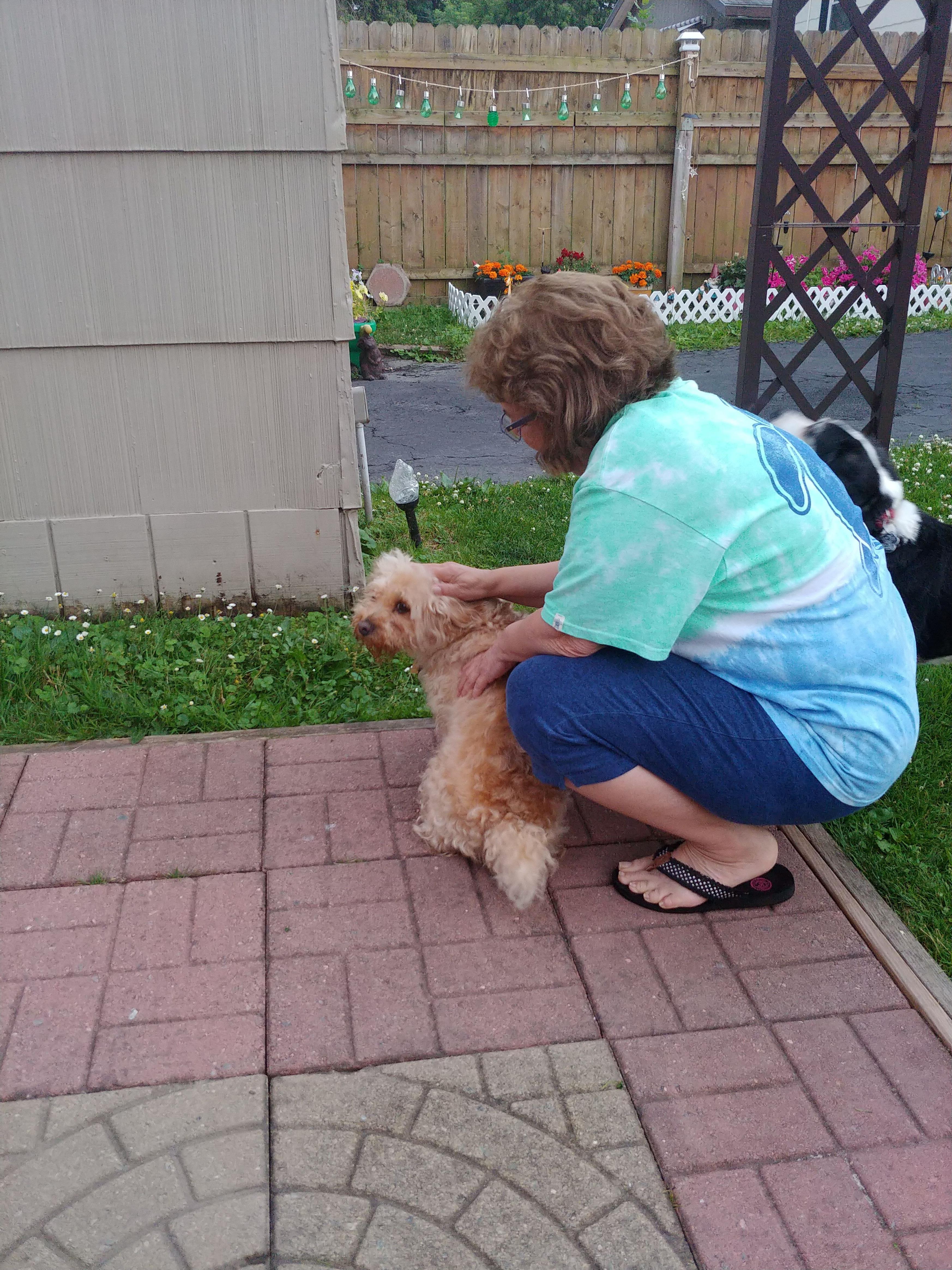 A woman petting a dog