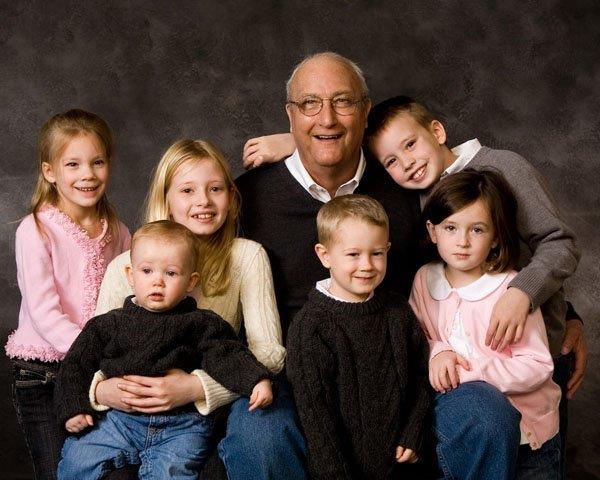 A man and several children posing for a photo