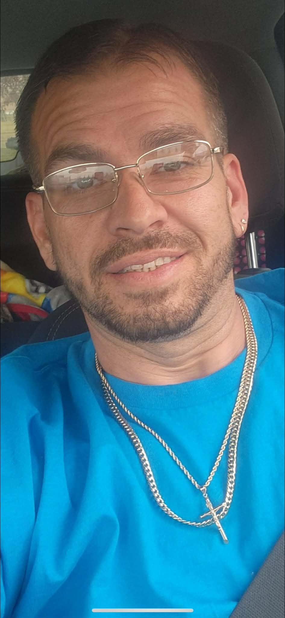 A man wearing glasses and a blue shirt