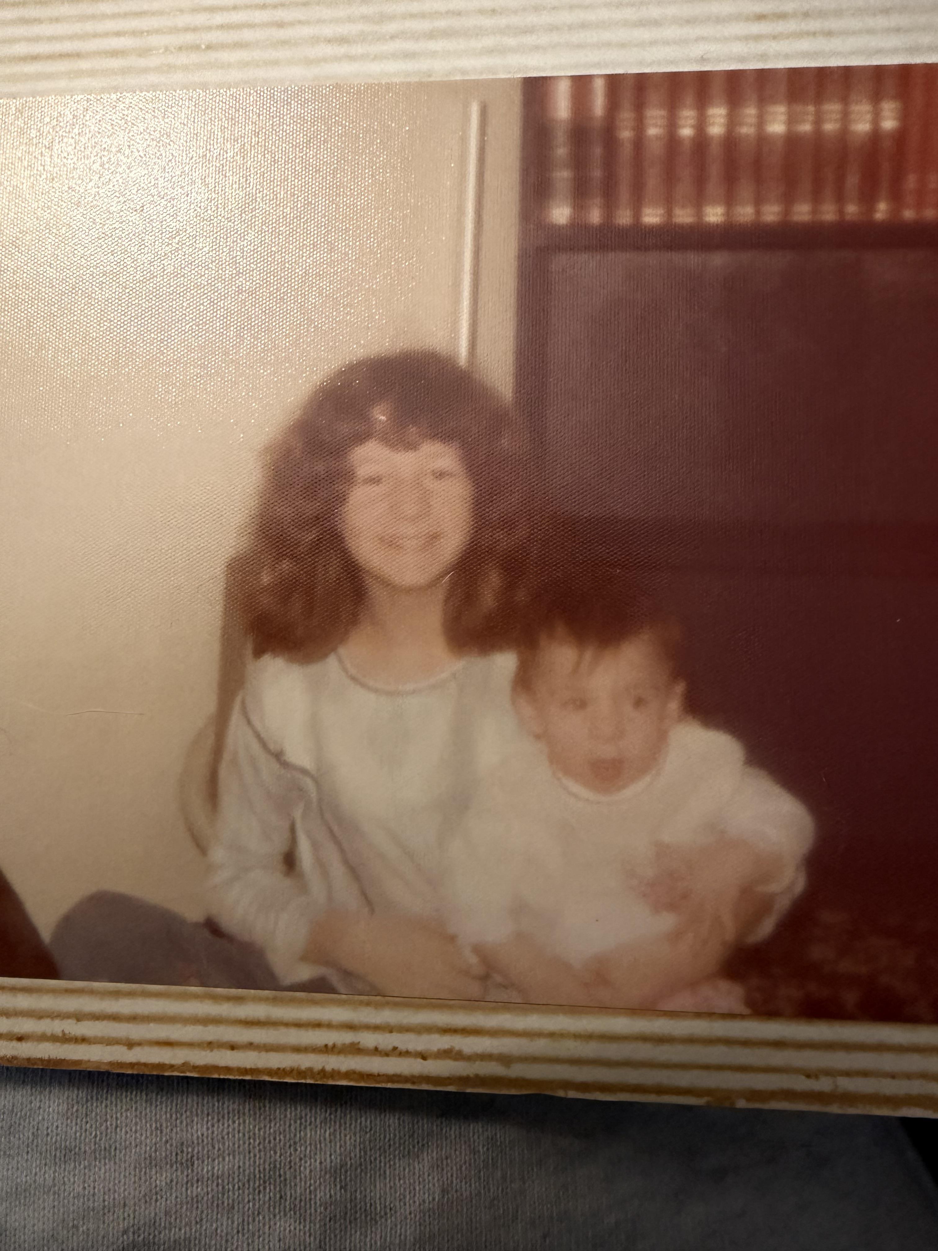 A girl holding a boy