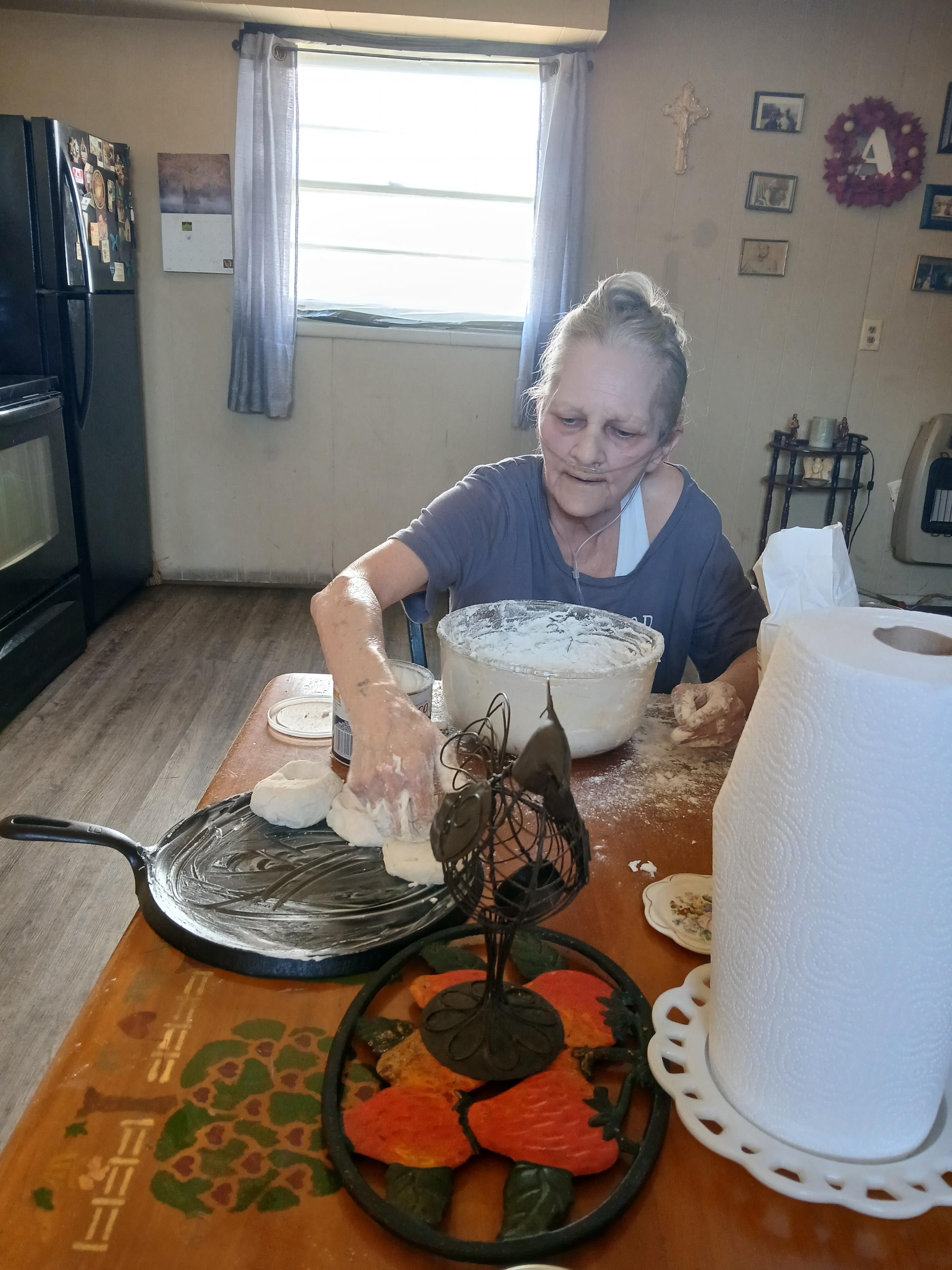 A woman sitting at a table with food on it