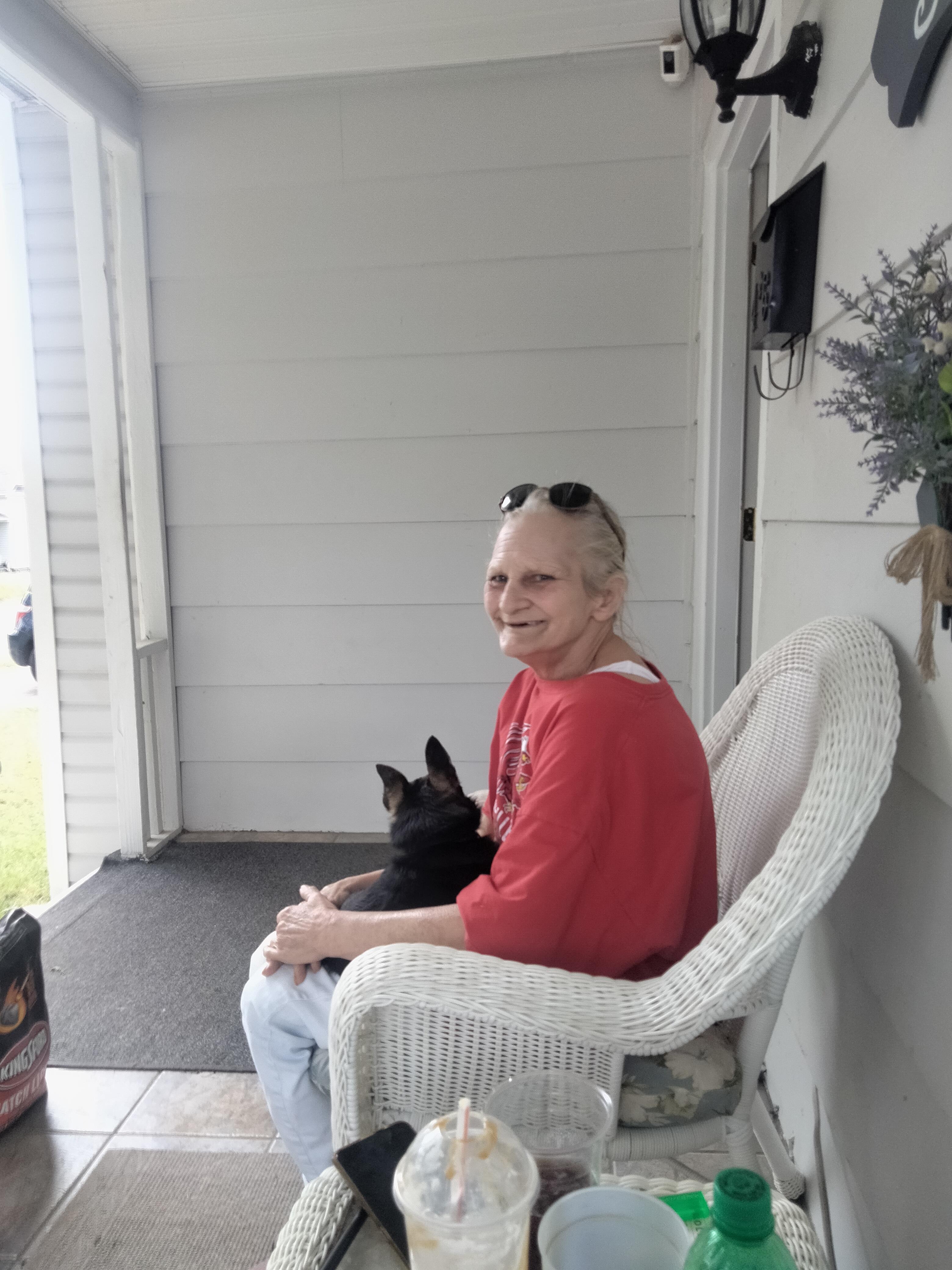 A woman sitting in a chair with a dog