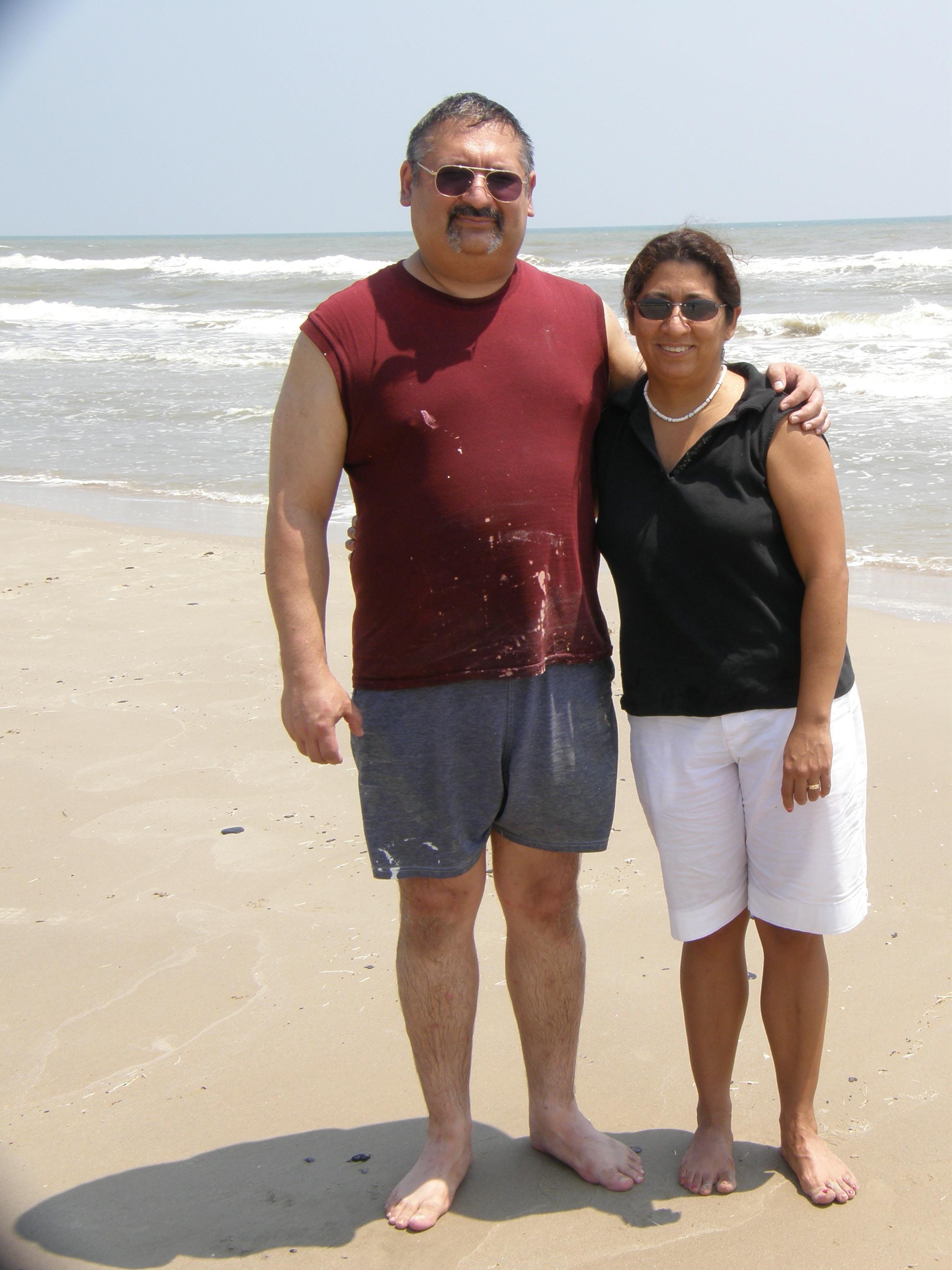 A man and woman standing on a beach