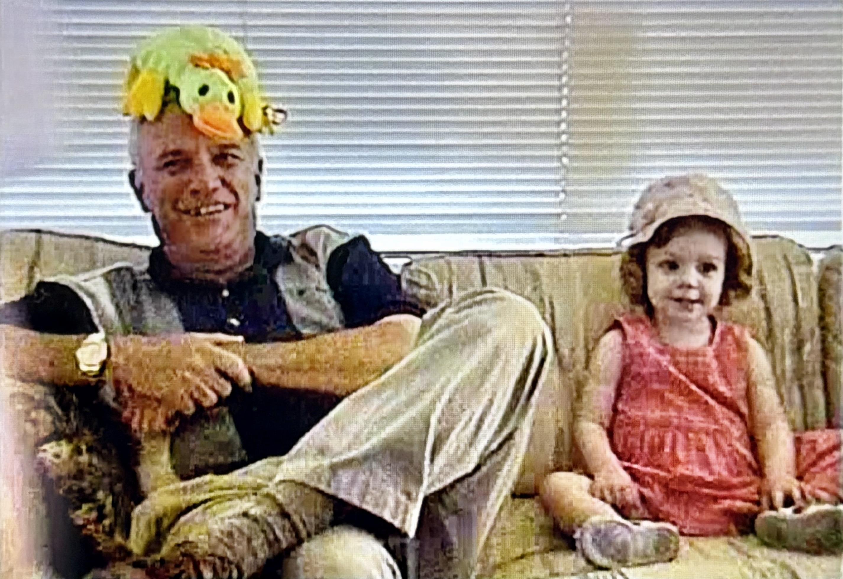 A man and a girl sitting on a couch
