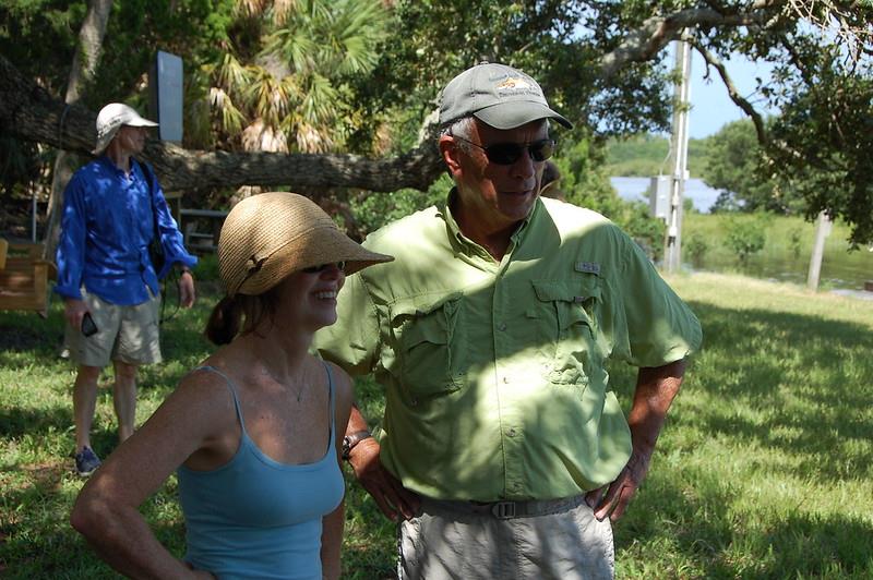 A man and woman standing in a grassy area