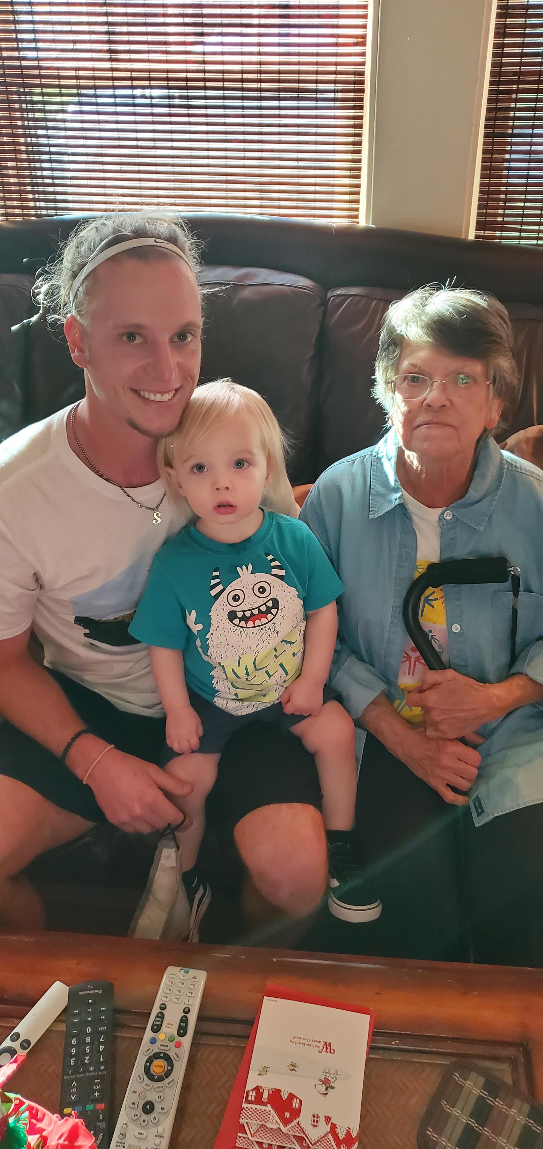 A man and woman posing for a picture with a baby