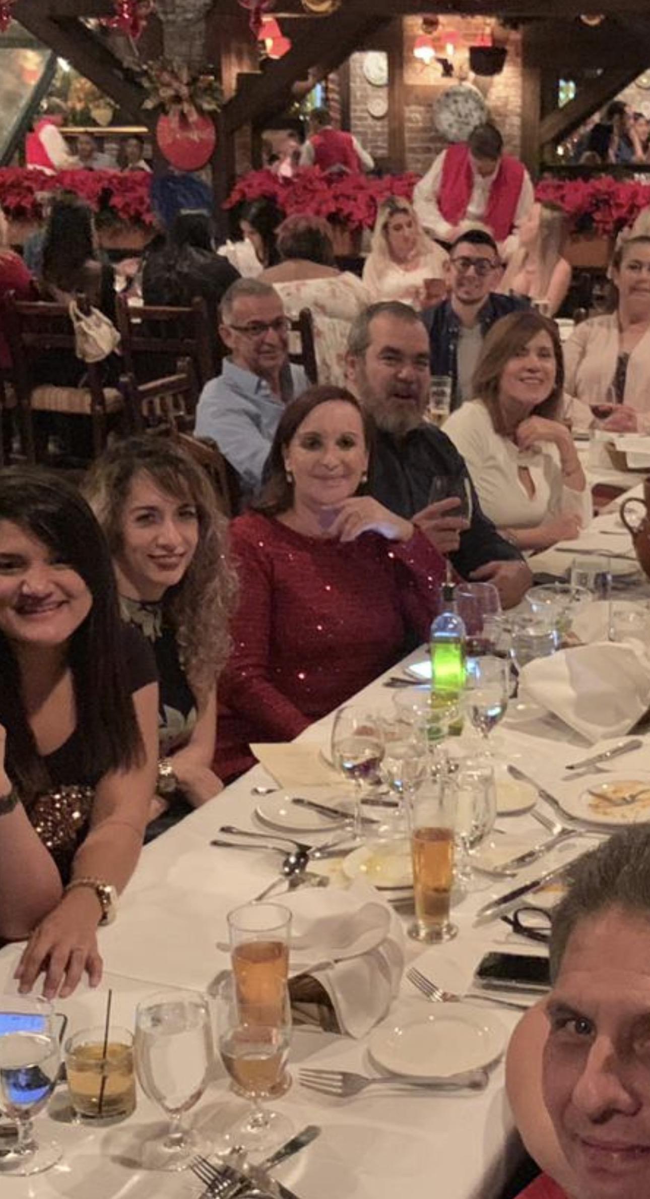 A group of people sitting at a long table