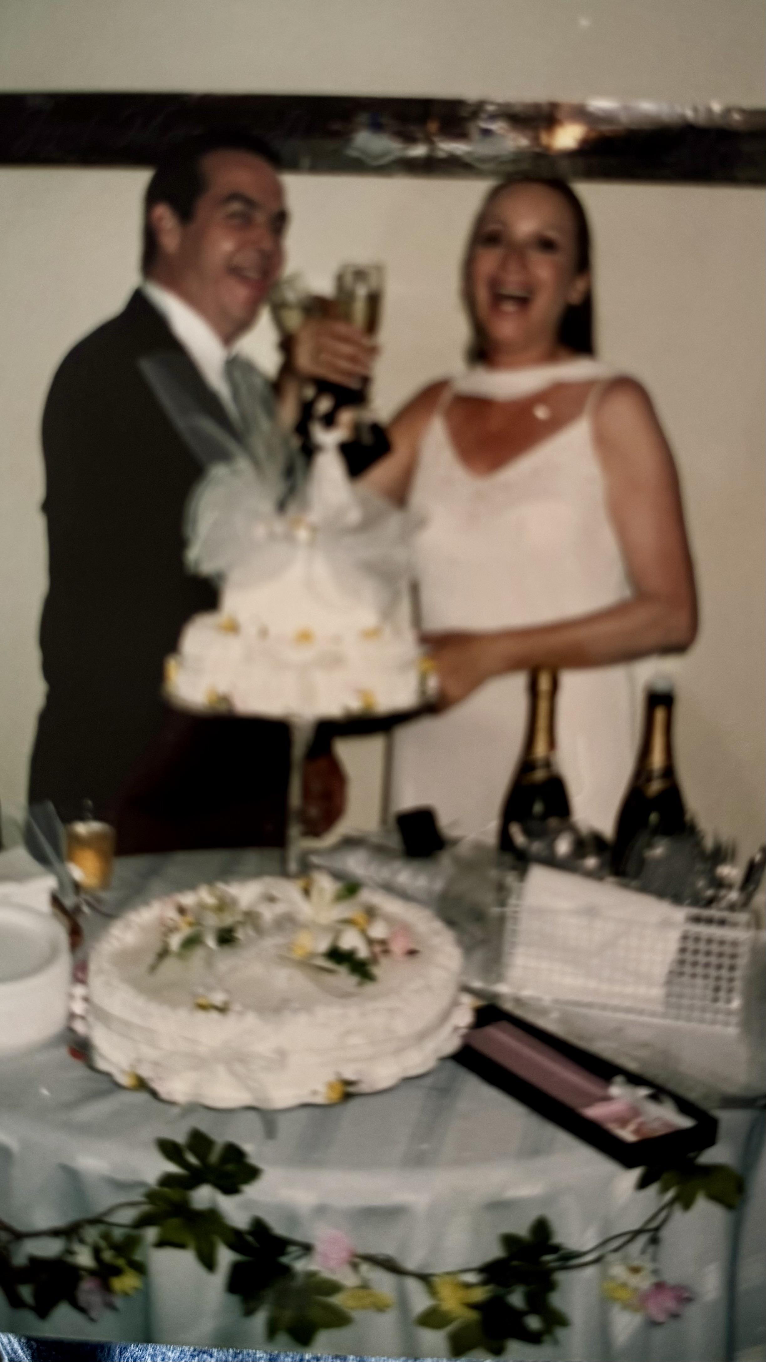 A man and woman holding a cake