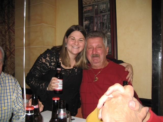 A man and woman holding bottles of beer