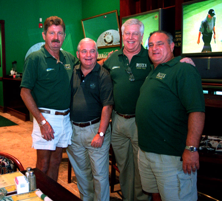 A group of men in green shirts