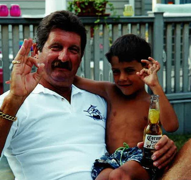 A man and boy holding a bottle
